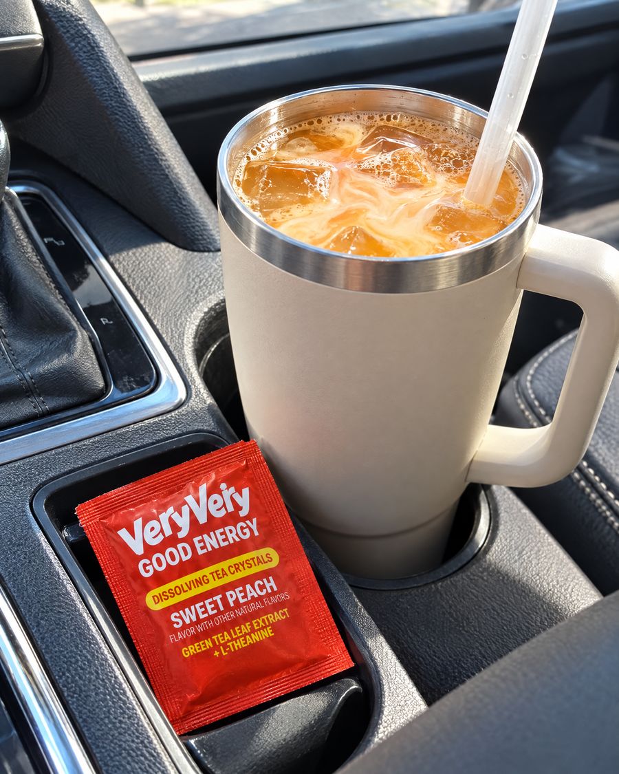 A tumbler of golden tea with a creamy orange swirl