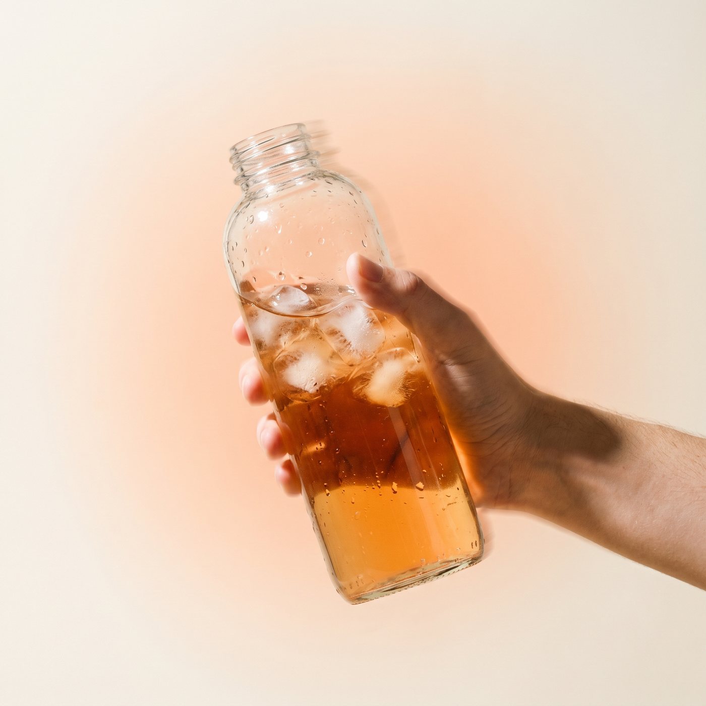 Shaking a bottle of peach iced tea