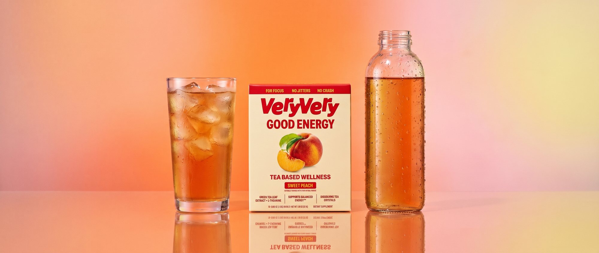 A glass of peach iced tea, the VeryVery box and a filled water bottle in a row